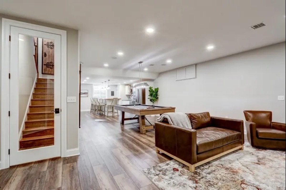 Finished basement remodel by Stauffer Custom Contracting, featuring a game room and living area