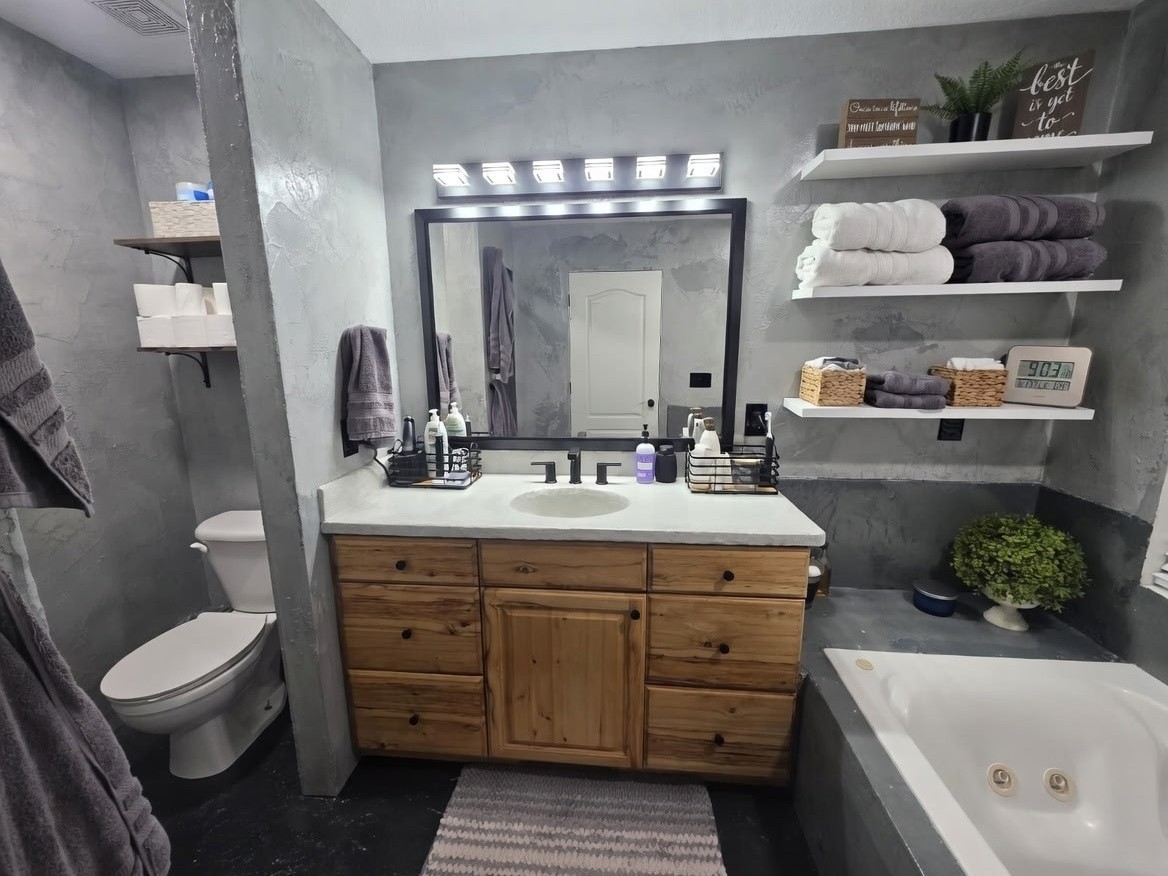 Finished bathroom remodel in American Fork, Utah with a custom concrete-inspired wall finish