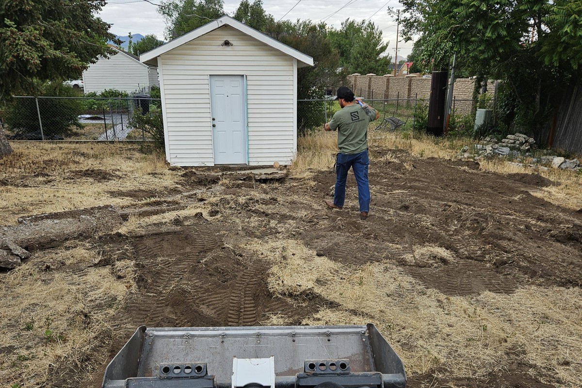 Stauffer Custom Contracting crew grading a yard as part of a landscape design project
